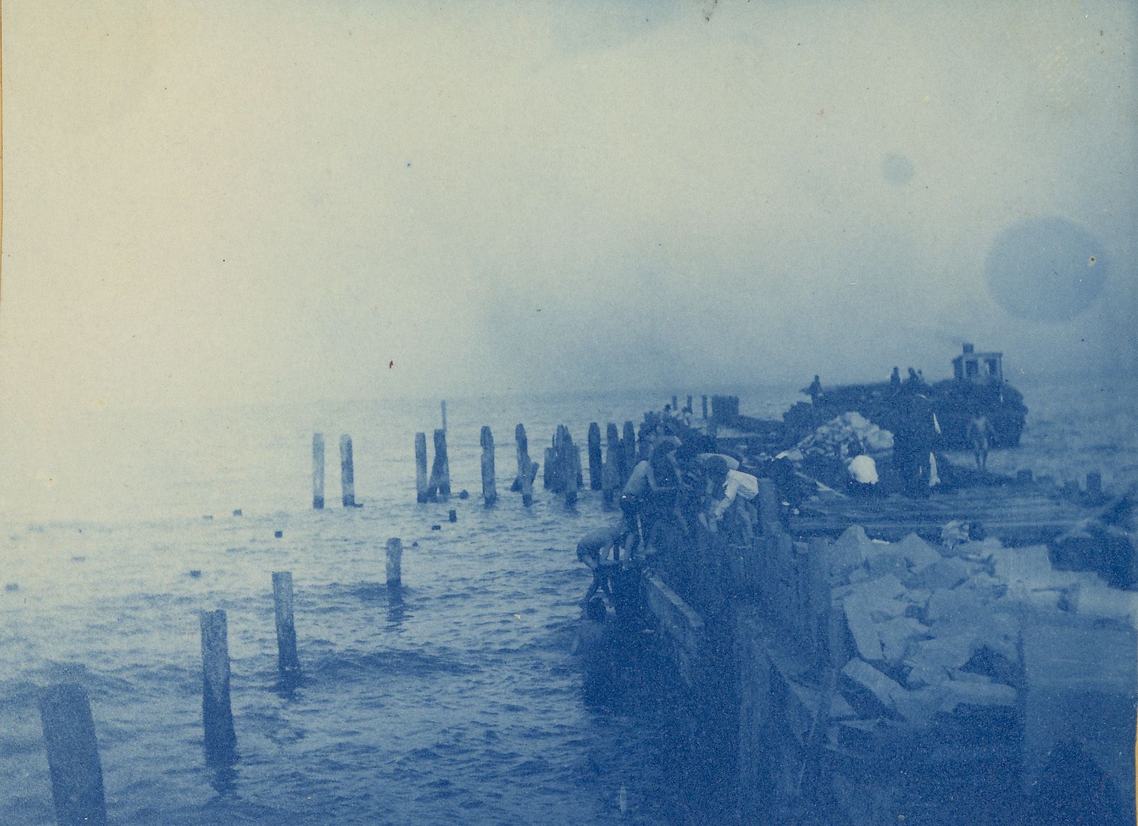 c. 1880s, from a Farwell family album. Repairing the ""old pier"" on Lake Michigan.