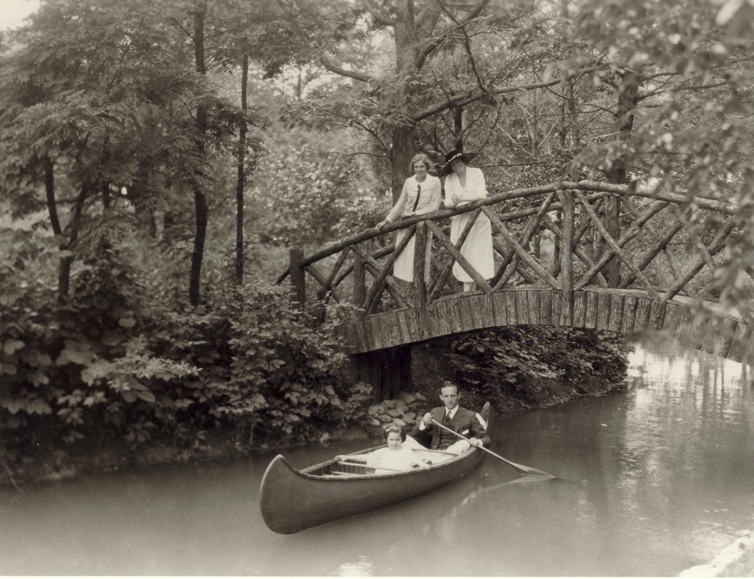 Farwell pond, c. 1923: Grace McGann; Lucia Woods Winston. In the canoe: Anne Winston, Farwell Winston.