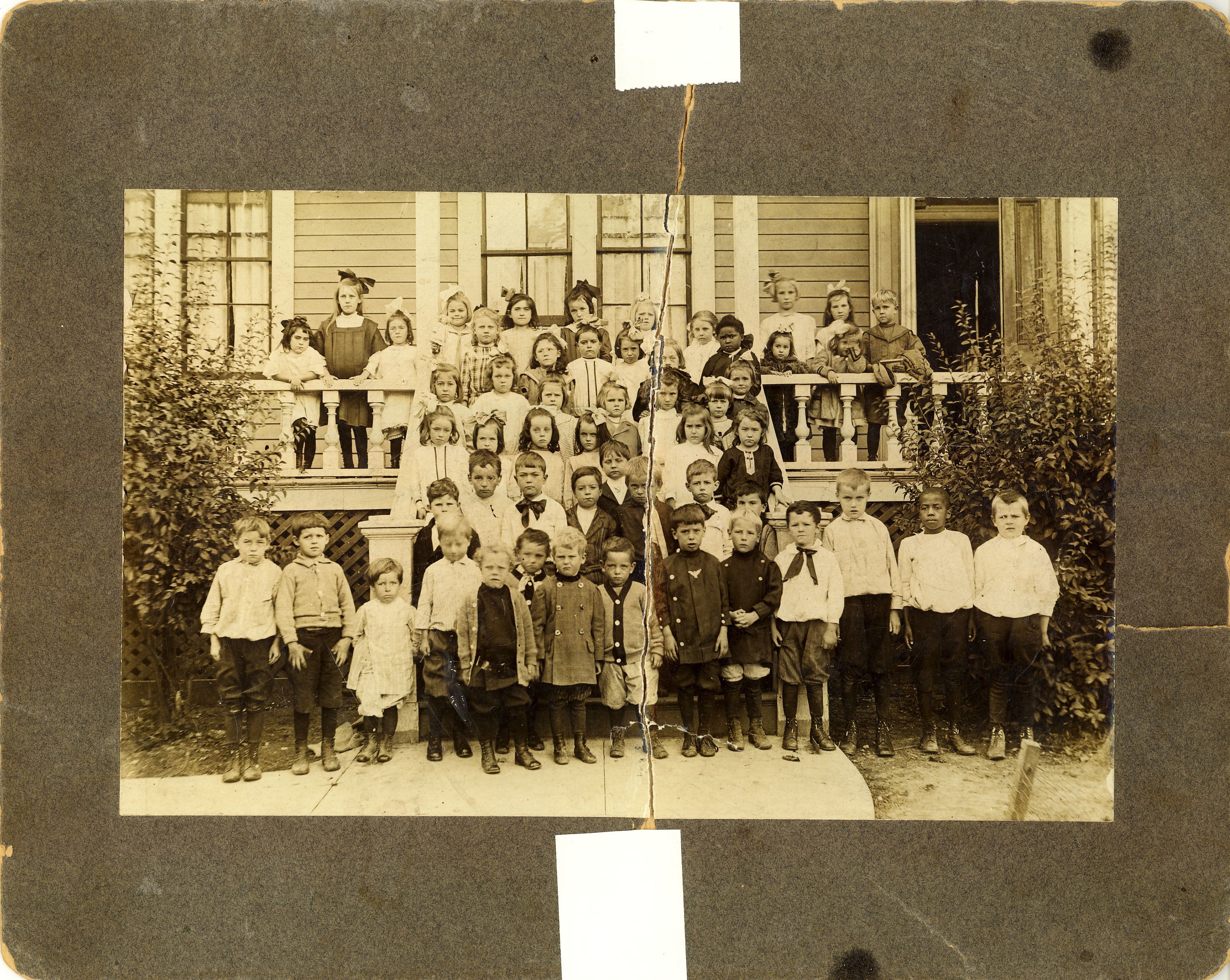 Here, early elementary students are pictured in front of South School c. 1910. Bottom row: Raymond Baldwin, Fred Dornbush, Eddie Peddle, Edward Gansberg, Arthur Johnson, Joseph McGovern, Arnold Carlson, Patrick Baldwin, Edward Boobyer, Oliver Lindenmeyer, Henry Beebe, Alfred Marwede, William Lenore, and William Haltenhoff. Second row: John Redmond, Richard Baldwin, Arthur Baker, Eddie Whalen, Frank Jaeger, Joseph Peddle, Christie Peterson, and Leonard Burns. Third row: Helen Peddle, Madeline Baldwin, Anne Mae McGovern, Sarah Jane McGovern, Doreen Hiscox, and Sadie Sage. Fourth row: Emily Bowman, Margaret Baldwin, Kathleen Ryan, Beth Jackson, Rebecca Preston, Madeline Ryan, and Mary Peddle. Fifth row: Rose Gansberg, Margaret Preston, Agnes Whalen, Mary Baldwin, and Fannie Rodgers.