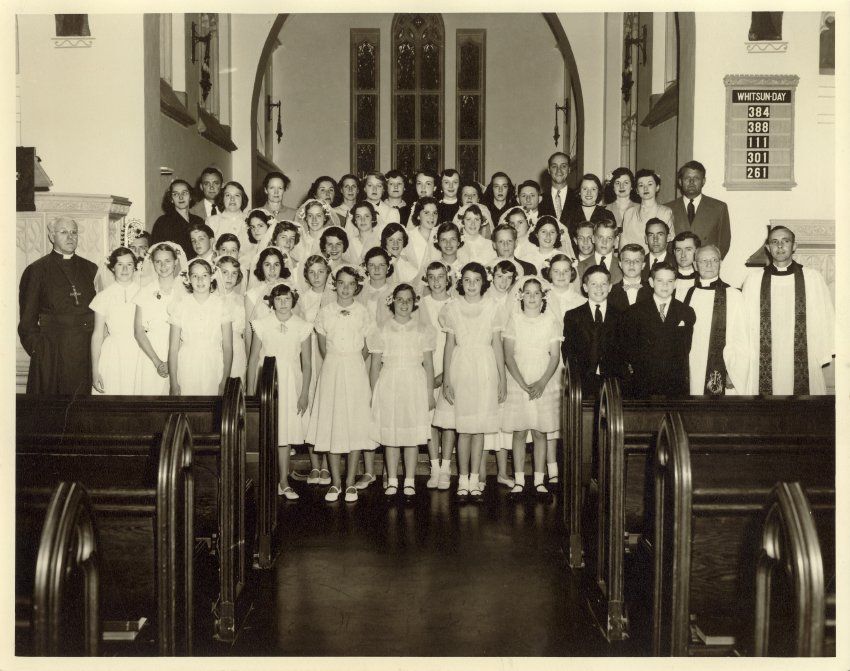 Children posing for a photo, perhaps at their First Communion.