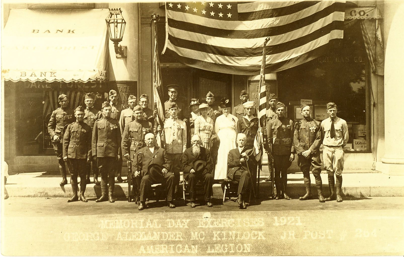 American Legion Post 264 in front of the bank building in Market Square, Memorial Day, 1921. Michael Fitzgerald is seated at left, next to two other local Civil War veterans.