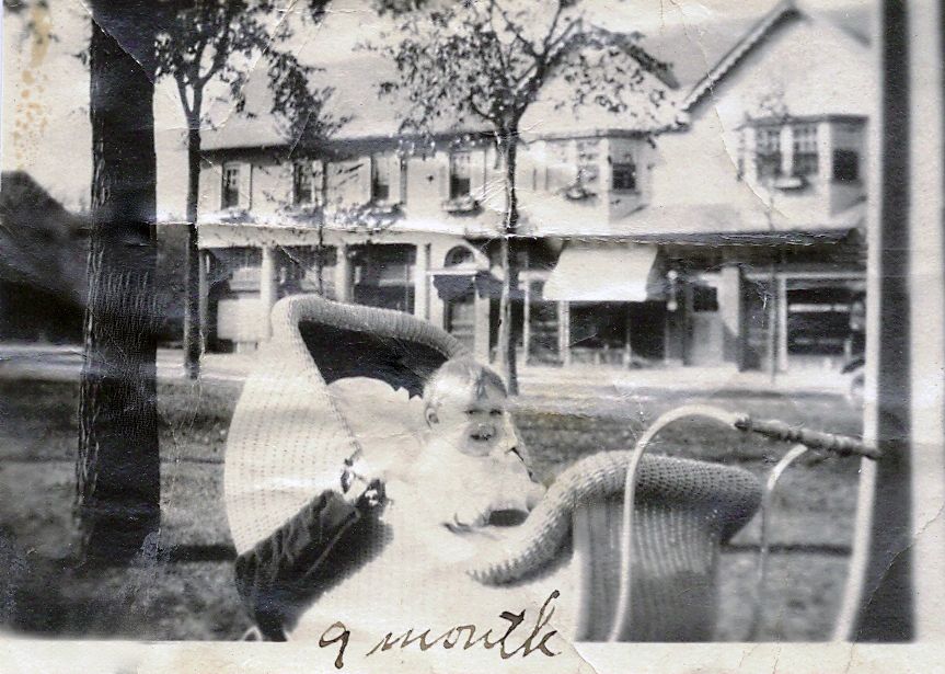 Fred Berghorn (9mos) in M.Sq] Fred Berghorn, age 9 months, in Market Square in 1920. His family lived in one of the second floor apartments, above the Sports Shop where his mother Ruth worked as a seamstress. Loan of Paula Berghorn Polito.