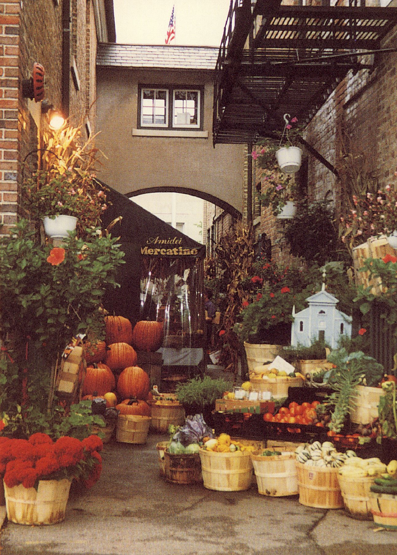Amidei Mercatino, a produce, flower and specialty open-air market run by Italian immigrant Ermanno Amidei and his wife Judith in the walkway between the former bank building and the former Young Men’s Club building. Pictured in 1996.