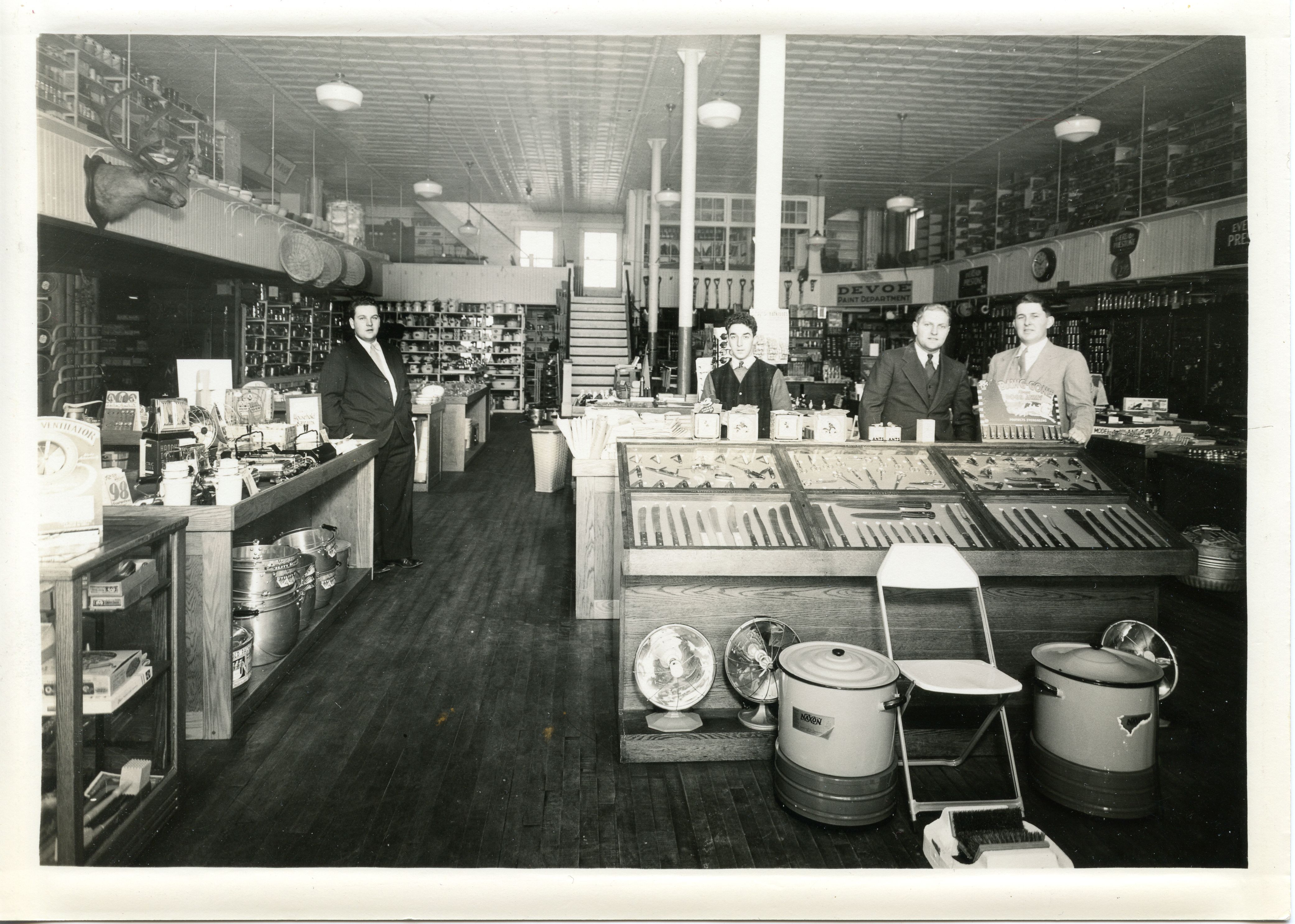O’Neill’s interior, c. 1940s. Left to right: Joseph O’Neill, Harold Julian, Ed O’Neill, unidentified. The prominent display of fans suggests it may be summertime.