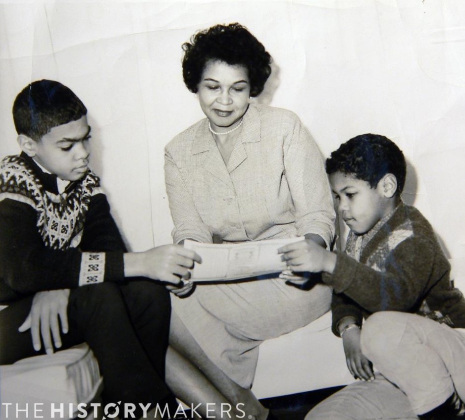 Caption: Bernice Narcisse Bacon (center) showing Robert "Bob" Bacon (left) and Kenneth Bacon (right) their shares at Riverside National Bank of Houston, the first African American owned bank in the state of Texas. Image courtesy of The HistoryMakers, Inc.